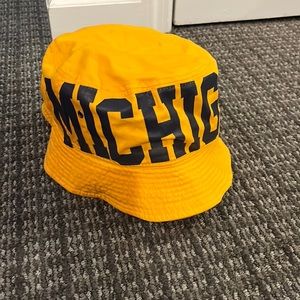 University of Michigan yellow bucket hat with navy letters. Never worn.